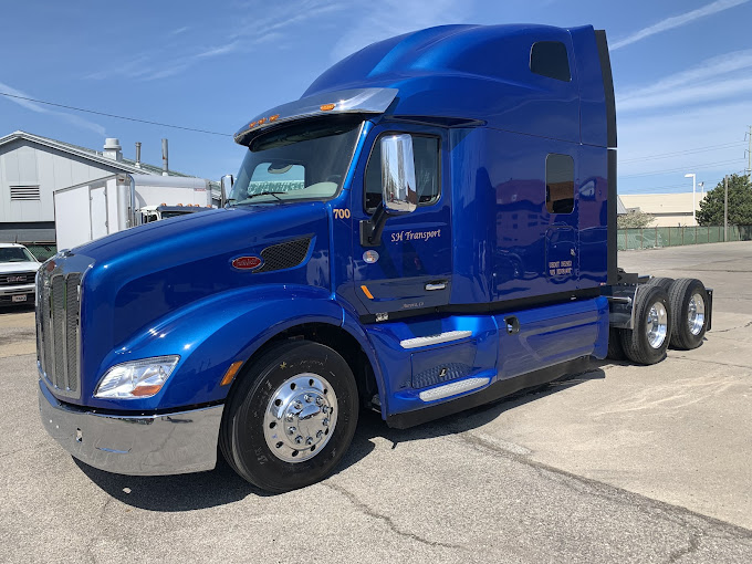 Professional blue Peterbilt semi truck at SH OH Truck Repair facility